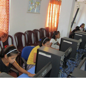 A girl learning on a computer in a skills class