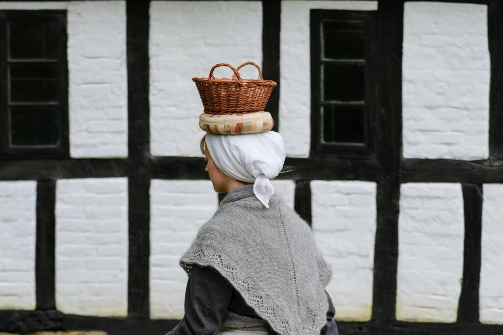 A woman carrying a basket on her head
